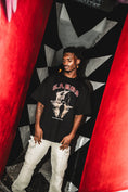 Load image into Gallery viewer, Black GABOS T-shirt between red walls